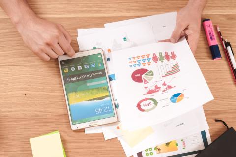 Paper reports spread out on desk