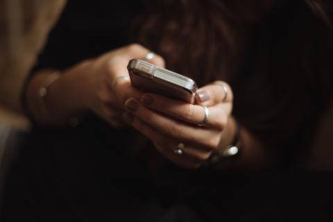 Pair of hands holding a mobile phone